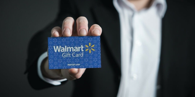 Customers shop at Sam's Club with a Walmart gift card